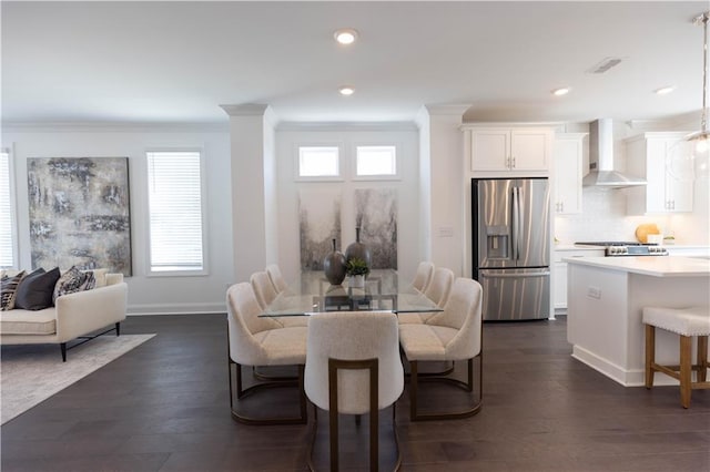 dining space featuring crown molding and dark hardwood / wood-style floors