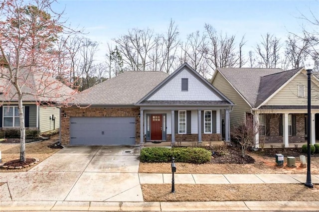 view of front of home featuring a garage, a porch, and concrete driveway