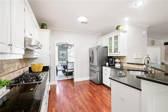 1558 Amberwood Creek Dr NW, Kennesaw, GA 30152 - kitchen featuring exhaust hood, stainless steel appliances, crown molding, white cabinetry, and wood finished floors
