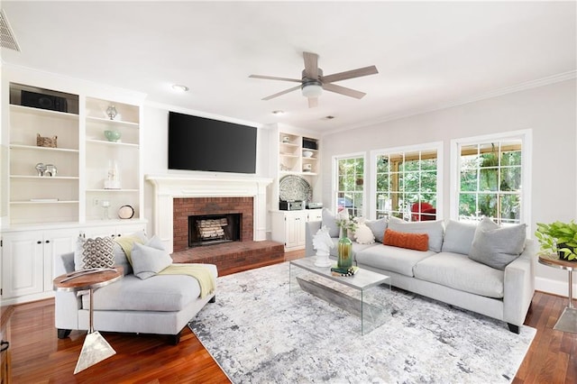 1558 Amberwood Creek Dr NW, Kennesaw, GA 30152 - living area with ceiling fan, crown molding, dark wood finished floors, built in features, and a brick fireplace