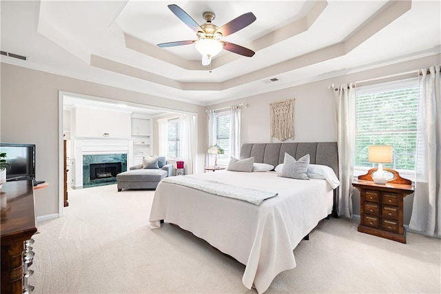 1558 Amberwood Creek Dr NW, Kennesaw, GA 30152 - bedroom featuring a raised ceiling, light carpet, a high end fireplace, a ceiling fan, and crown molding