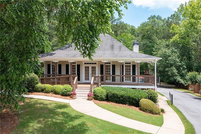 1558 Amberwood Creek Dr NW, Kennesaw, GA 30152 - view of front of property with french doors, covered porch, a chimney, a front lawn, and a shingled roof