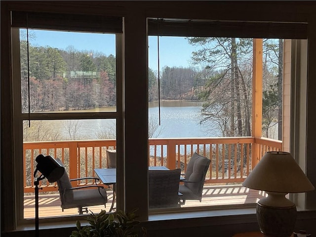 sunroom / solarium featuring a water view