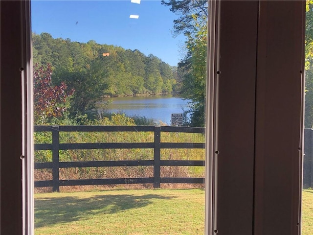 view of water feature with fence and a view of trees