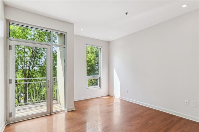 unfurnished room featuring hardwood / wood-style flooring