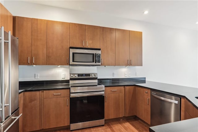 kitchen featuring light wood-type flooring and appliances with stainless steel finishes