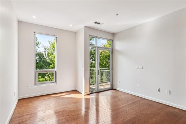 spare room with hardwood / wood-style flooring