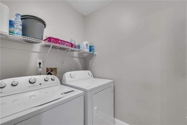 clothes washing area with washer and dryer