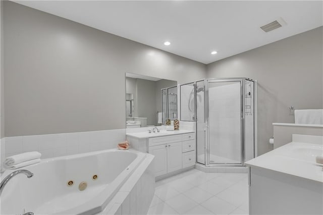 bathroom with plus walk in shower, tile patterned floors, and vanity