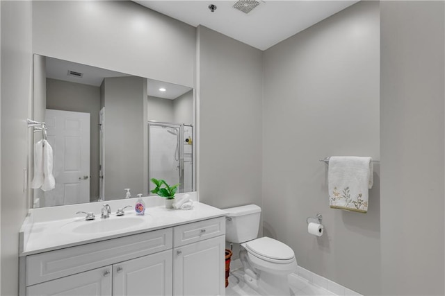 bathroom featuring a shower with door, vanity, and toilet