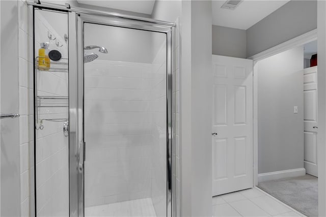 bathroom featuring a shower with door and tile patterned flooring