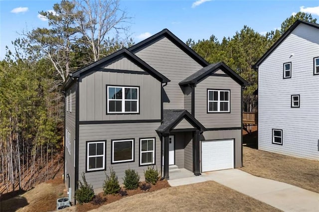 view of front of house featuring driveway, board and batten siding, and an attached garage