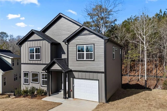 view of front facade with an attached garage, driveway, and board and batten siding