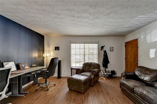 office area featuring wood-type flooring and a textured ceiling