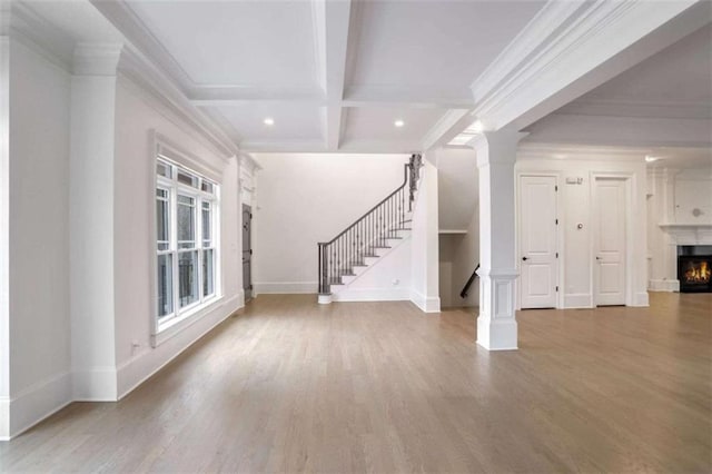 interior space featuring coffered ceiling, wood-type flooring, ornamental molding, beamed ceiling, and ornate columns