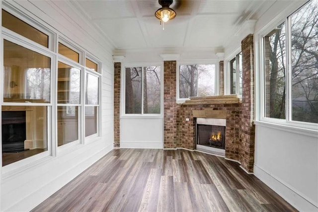 unfurnished sunroom with a brick fireplace