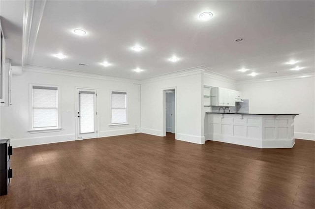 unfurnished living room with dark wood-type flooring and ornamental molding