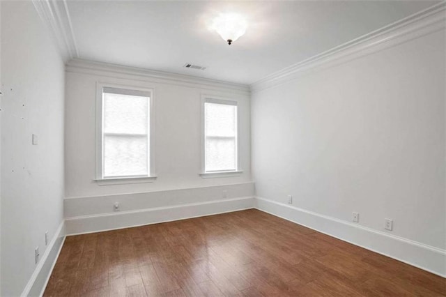 unfurnished room with hardwood / wood-style flooring and ornamental molding