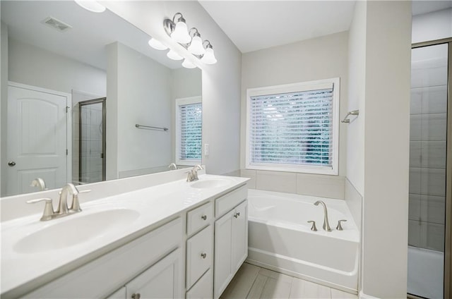 full bathroom with a bath, a shower with shower door, and double vanity