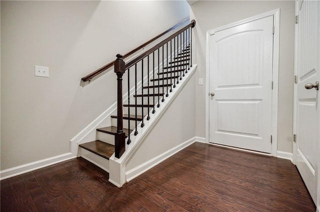 stairway featuring wood finished floors and baseboards