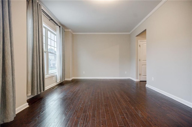 empty room with wood-type flooring, ornamental molding, and baseboards