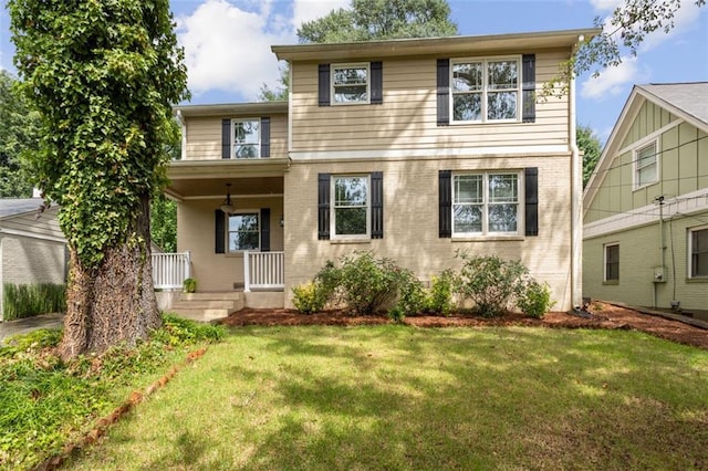 view of front of home with a porch and a front lawn