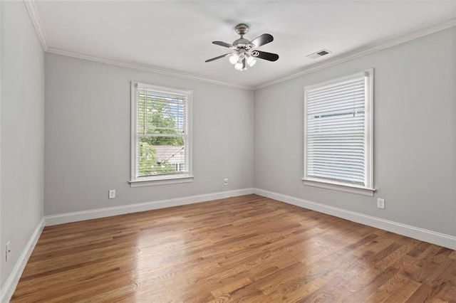 spare room featuring ceiling fan, ornamental molding, and light hardwood / wood-style floors