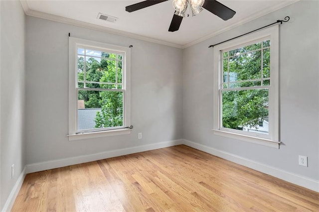 unfurnished room featuring ornamental molding, ceiling fan, a healthy amount of sunlight, and light wood-type flooring