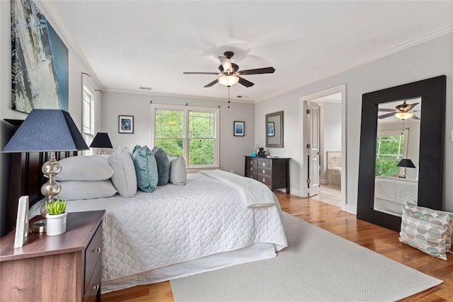 bedroom with ceiling fan, multiple windows, ornamental molding, and hardwood / wood-style flooring