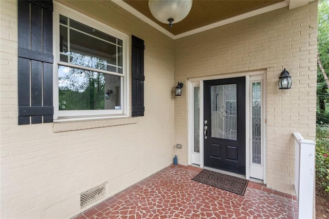 view of exterior entry with covered porch