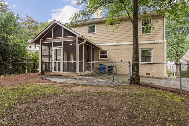 back of property with a sunroom