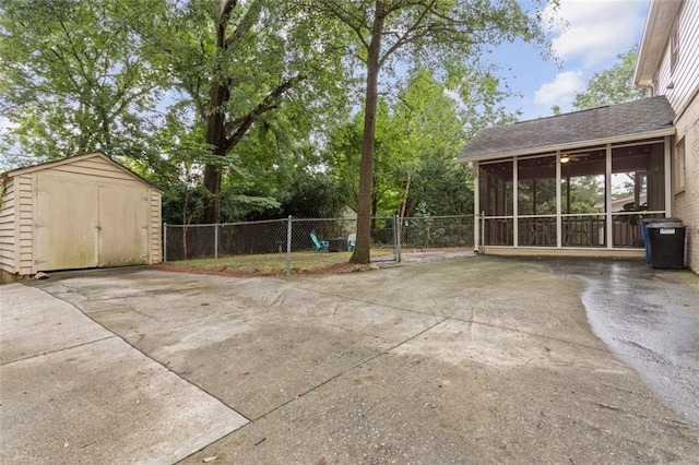 view of terrace with a sunroom and a storage unit