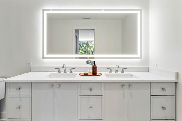 bathroom with a sink and double vanity