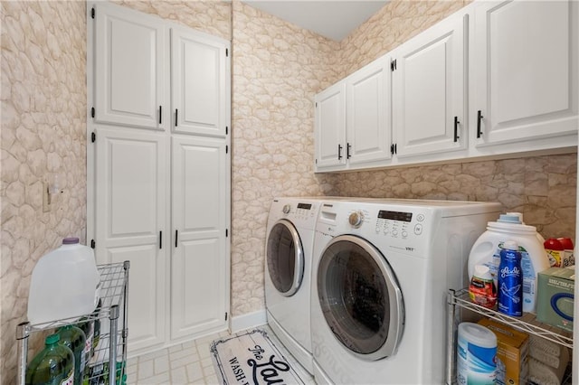 laundry area with washer and dryer, cabinets, and light tile patterned flooring