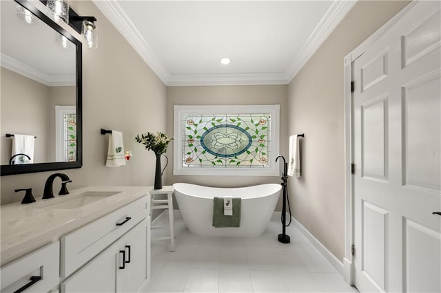 bathroom featuring tile patterned floors, ornamental molding, vanity, and a bathtub