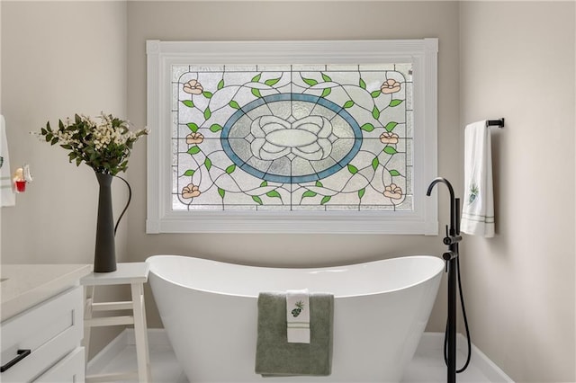 bathroom featuring a tub and vanity