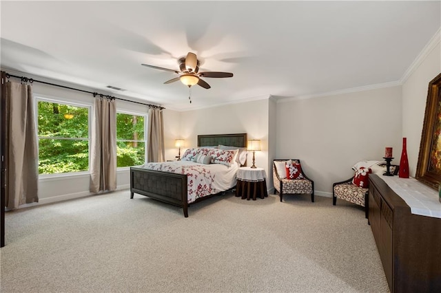 carpeted bedroom with ceiling fan and crown molding