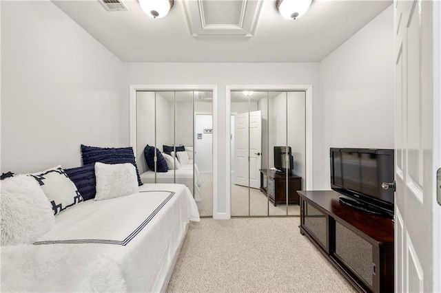 carpeted bedroom with two closets