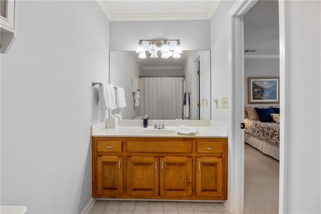 bathroom with crown molding, tile patterned flooring, and vanity