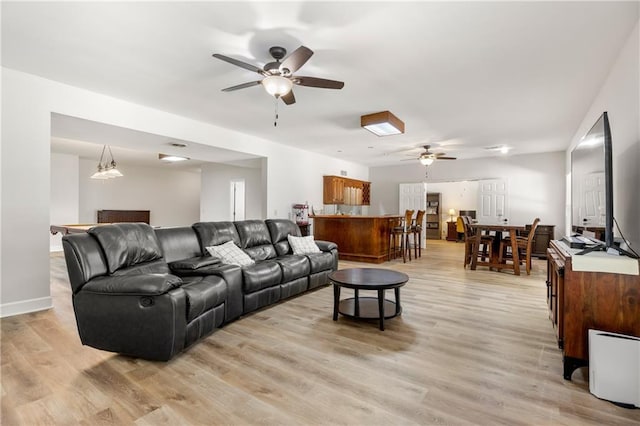 living room featuring light wood-type flooring and ceiling fan