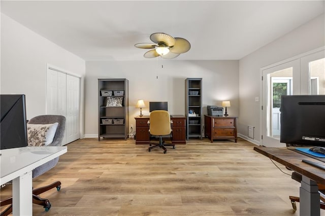 home office featuring ceiling fan and light hardwood / wood-style flooring