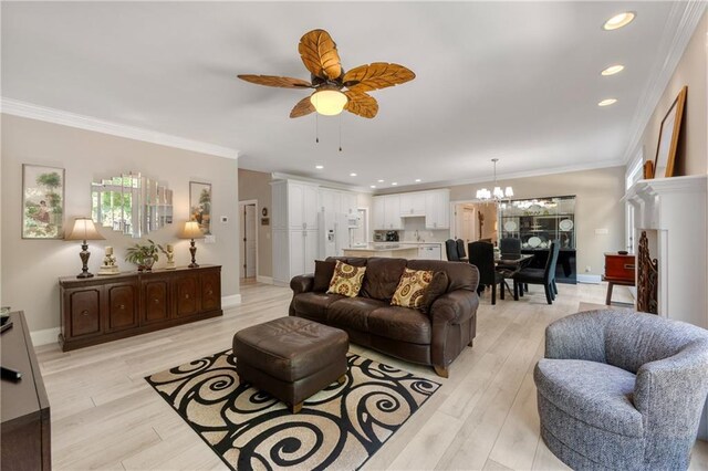 living room with ceiling fan with notable chandelier, crown molding, and light hardwood / wood-style flooring