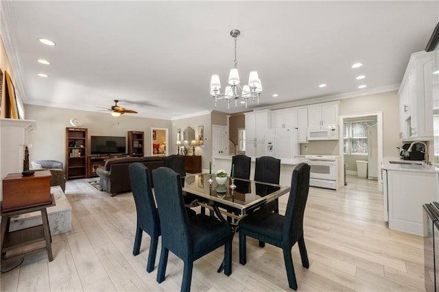 dining area featuring light hardwood / wood-style flooring and crown molding