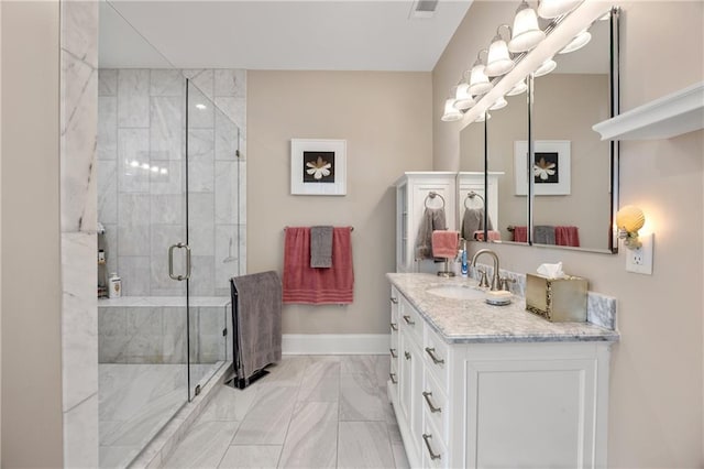 bathroom featuring tile patterned flooring, an enclosed shower, and vanity