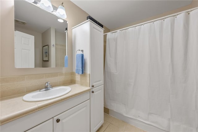 bathroom featuring tile patterned floors, vanity, and decorative backsplash