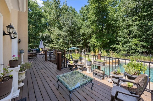 deck featuring a fenced in pool