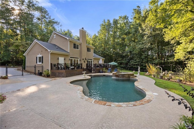 view of pool with a deck, a patio, and an in ground hot tub