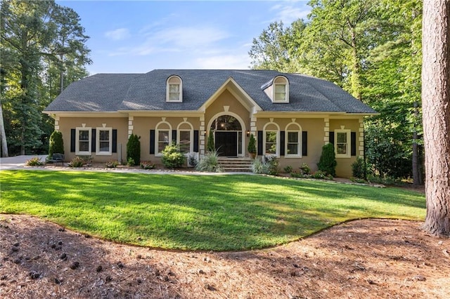 cape cod-style house with covered porch and a front lawn