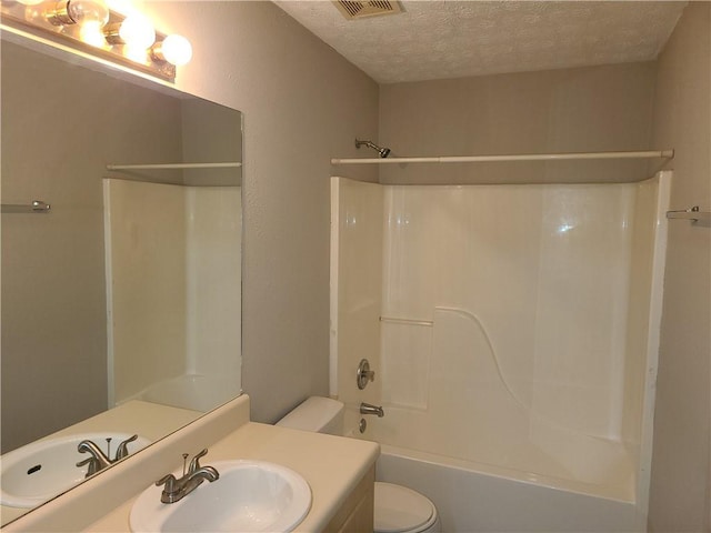 bathroom featuring visible vents, toilet, a textured ceiling, bathtub / shower combination, and vanity