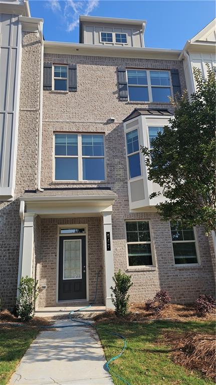 547 Fundao Ln # 24, Lawrenceville, GA 30046 - townhome / multi-family property with board and batten siding and brick siding